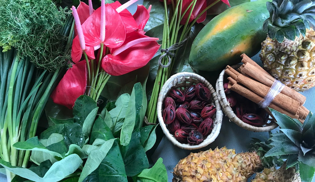 A selection of flowers, fruit and spices in Soufriere market