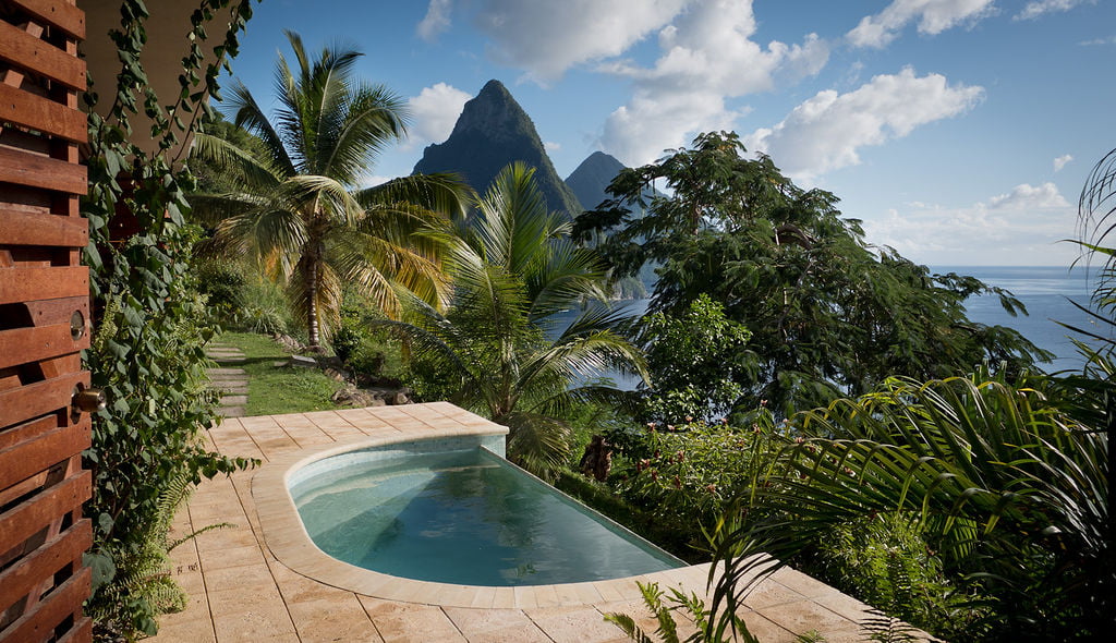 The plunge pool on a terrace outside the Garden Studios at Cosmos St Lucia, with the Pitons rising in the distance
