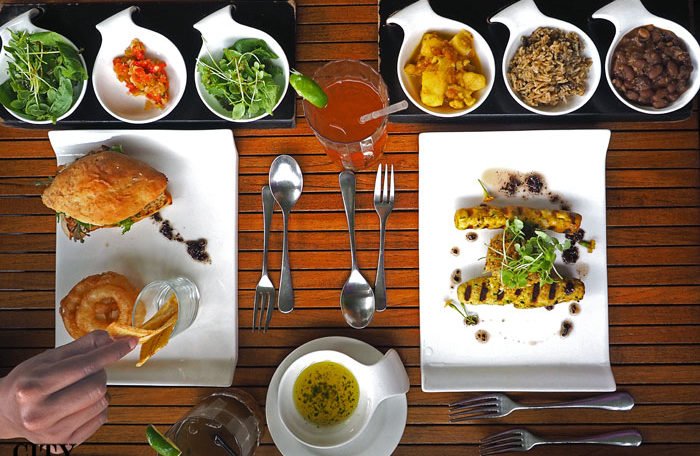 An overhead shot of a meal at Bouchan restaurant, showing the main dish surrounded by colourful side dishes