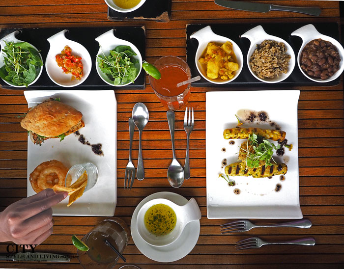 An overhead shot of a meal at Bouchan restaurant, showing the main dish surrounded by colourful side dishes
