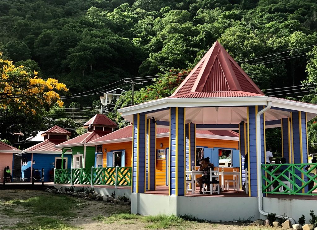 Carribean beach huts painted in bright primary colours